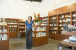 Mixed race business owner standing in beauty product store