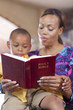 Mother reading bible to son