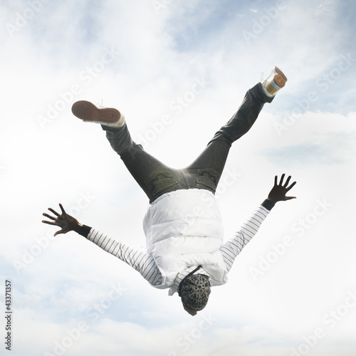 Photo: African American man upside-down in the air African American man upside-down in the air