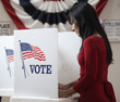 Asian voter voting in polling place