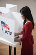 Asian voter voting in polling place