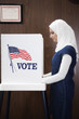 Middle Eastern voter voting in polling place