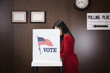 Asian voter voting in polling place