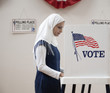 Middle Eastern voter voting in polling place