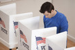 Caucasian voter voting in polling place