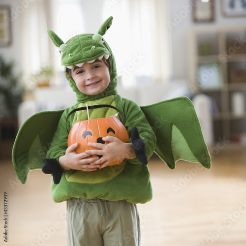 Photo: Mixed race boy in Halloween dragon costume Mixed race boy in Halloween dragon costume