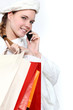 young woman holding shopping bags and talking on her  cell