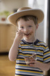 Caucasian boy in cowboy hat eating pudding