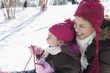 Hispanic girls sledding down snow covered hill