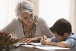 Caucasian grandmother helping grandson with homework