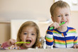 Caucasian brother and sister brushing teeth
