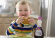 Caucasian boy eating pancakes