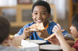 Boys eating pizza together