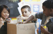 Boys packing box with food for school food drive