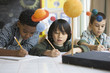Boys studying the planet model in classroom