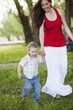 Caucasian mother and son holding hands