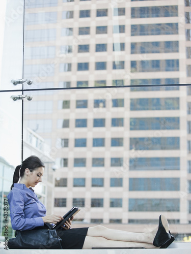 Photo: Caucasian businesswoman using digital tablet Caucasian businesswoman using digital tablet