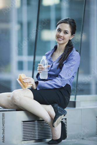 Photo: Caucasian businesswoman eating lunch Caucasian businesswoman eating lunch