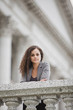 Serious Caucasian businesswoman leaning on railing