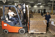 Hispanic worker driving forklift in warehouse