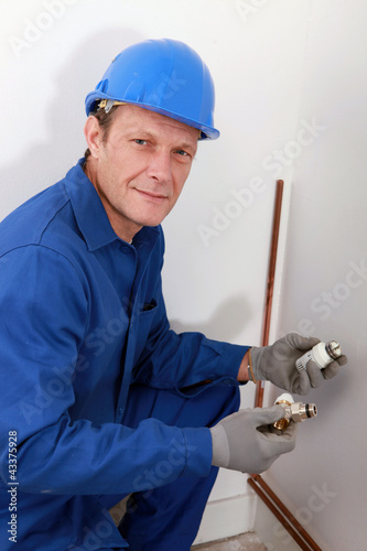 Photo: Plumber fixing heating system Plumber fixing heating system