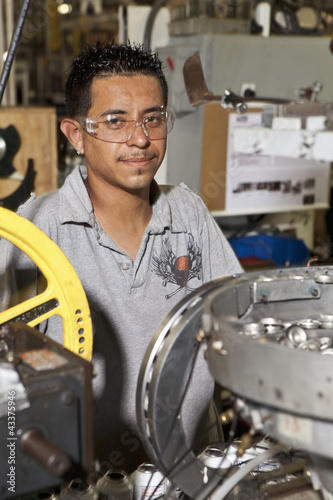 Photo: Hispanic man working on assembly line Hispanic man working on assembly line