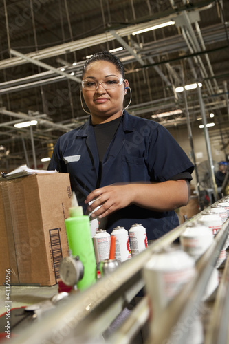 Photo: Hispanic woman working on assembly line Hispanic woman working on assembly line