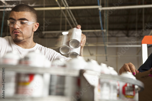 Photo: Hispanic woman working on assembly line Hispanic woman working on assembly line