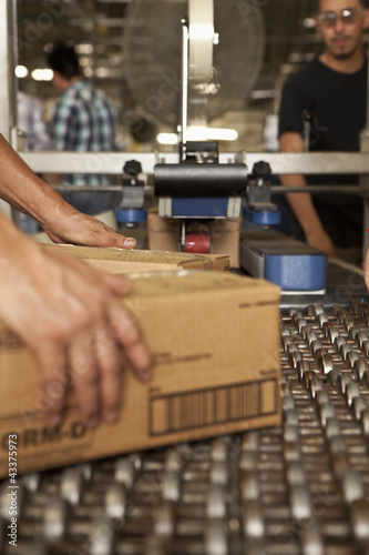 Photo: Workers working on assembly line Workers working on assembly line