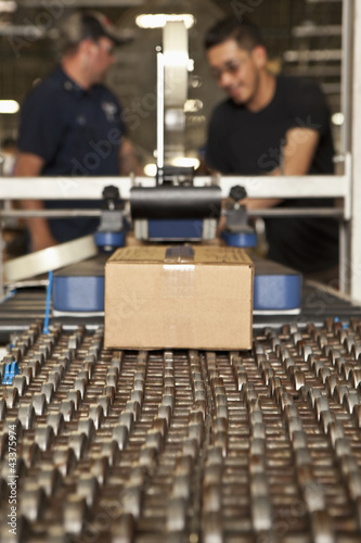 Photo: Workers working on assembly line Workers working on assembly line