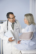 Doctor talking to patient in examination room