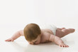Caucasian baby boy laying on ground