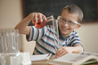 Caucasian boy doing experiment in chemistry class