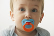 Mixed race baby boy sucking pacifier