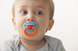 Mixed race baby boy sucking pacifier