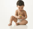 Mixed race baby girl playing with alphabet blocks