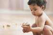 Mixed race baby girl playing with alphabet blocks