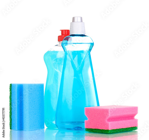 Photo: Dishwashing liquids and sponge isolated on white Dishwashing liquids and sponge isolated on white