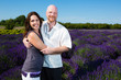 Happy middled aged couple in a field of purple lavender