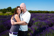 Happy middled aged couple in a field of purple lavender