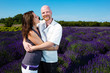 Happy middled aged couple in a field of purple lavender