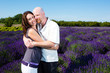 Happy middled aged couple in a field of purple lavender