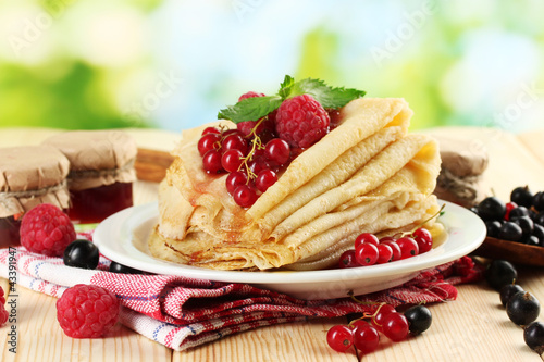 Photo: pancakes with berries, jam and honey pancakes with berries, jam and honey