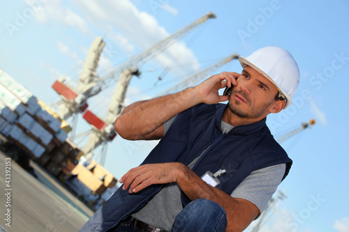 Photo: foreman on the phone in construction site foreman on the phone in construction site