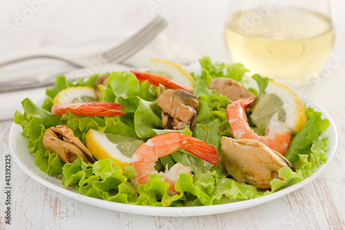 Photo: salad with shrimps and mussels on the plate salad with shrimps and mussels on the plate