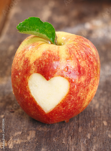 Photo: Ripe red apple with heart shape Ripe red apple with heart shape