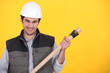 Builder with a wooden handled tool