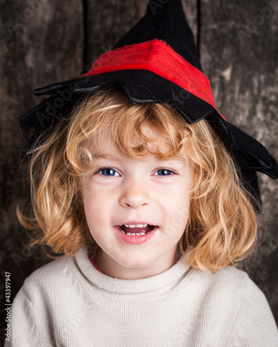 Foto: Funny kid in hand of witch Funny kid in hand of witch