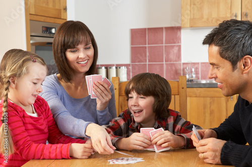 Photo: Family Playing Cards In Kitchen Family Playing Cards In Kitchen