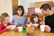 Photo: Family Eating Breakfast Together In Kitchen Family Eating Breakfast Together In Kitchen